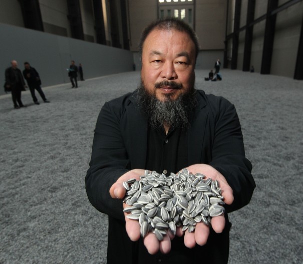 LONDON, ENGLAND - OCTOBER 11: Chinese Artist Ai Weiwei holds some seeds from his Unilever Installation 'Sunflower Seeds' at The Tate Modern on October 11, 2010 in London, England. The sculptural installation comprises 100 million handmade porcelain replica sunflower seeds. Visitors to the Turbine Hall will be able to walk on the work - which opens on October 12, 2010 and runs until May 2, 2011. (Photo by Peter Macdiarmid/Getty Images)